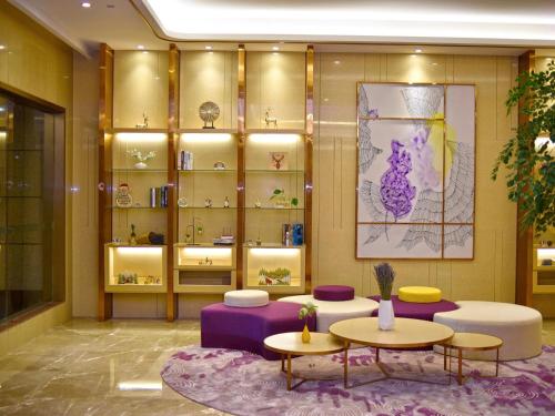 a room with two tables and shelves of furniture at Lavande Hotel Fuzhou Wanda Plaza High-speed Railway Station in Fuzhou