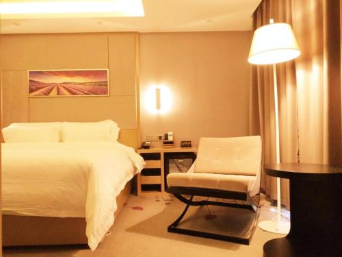 a bedroom with a bed and a chair and a desk at Lavande Hotel Jinan Second Ring East Road Quanfu Overpass Branch in Jinan