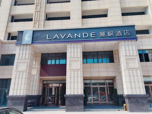 a building with a sign on the front of it at Lavande Hotel Tangshan Convention and Exhibition Yuanyang City in Tangshan