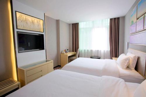 Katil atau katil-katil dalam bilik di Lavande Hotel (Xinyi Fuhai Building Branch)