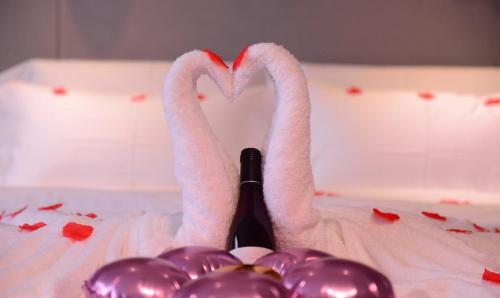 two swans making a heart with a bottle of champagne at Lavande Hotel Linyi People's Square Branch in Linyi