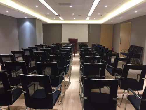 a room with rows of chairs and a podium at Lavande Hotel (Harbin Ice and Snow World University of Commerce Branch) in Harbin