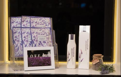 a shelf with two bottles and a picture and a box at Lavande Hotel Chaozhou Plaza Branch in Chaozhou