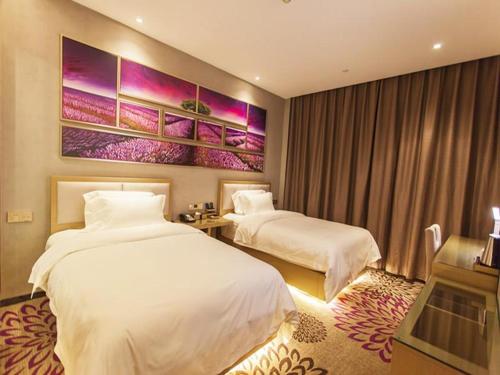 pokój hotelowy z 2 łóżkami i obrazem na ścianie w obiekcie Lavande Hotel Jinzhong Yuci Walmart Branch w mieście Jinzhong