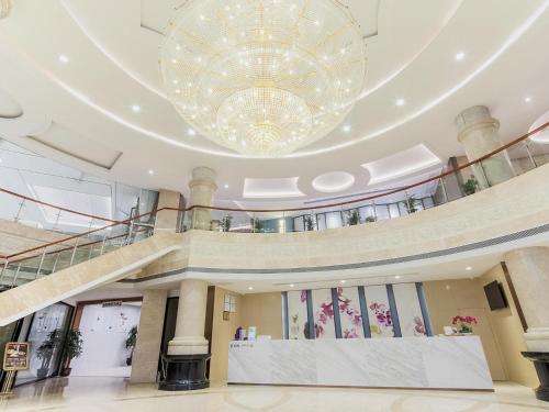 a large chandelier hangs from the ceiling of a building at Lavande Hotel Changsha Xingsha Center in Xingsha