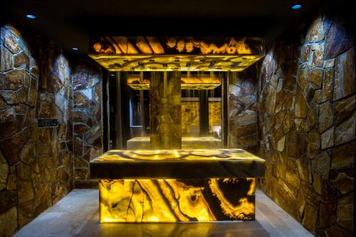 a stone walled room with a fountain in a building at Hotel Zalewski in Mrzeżyno