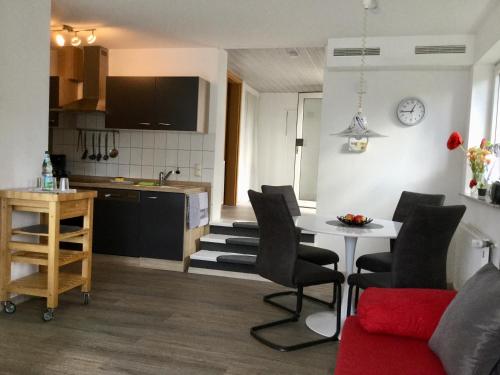 eine Küche und ein Wohnzimmer mit einem Tisch und Stühlen in der Unterkunft Ferienwohnung im Naturpark Rhein-Westerwald in Rengsdorf
