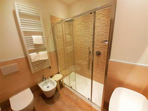 a bathroom with a shower and a toilet and a sink at Park Hotel Val Di Monte ***S in Malcesine