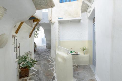 a hallway of a house with white walls and a table at Venetian Suites in Naxos Chora