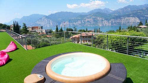 a hot tub on the balcony of a house at Park Hotel Val Di Monte ***S in Malcesine