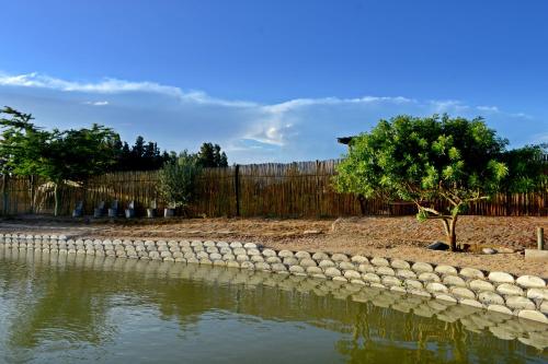 a retaining wall next to a body of water at Klein Plekkie Self Catering Accommodation in Addo