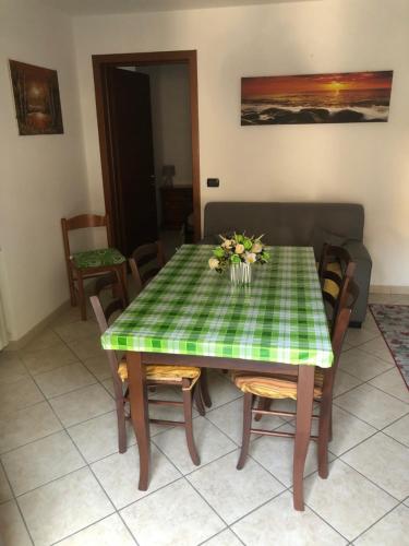 a dining room table with a green checkered table cloth at B&B Le Due Gemme Marsaglia in Marsaglia