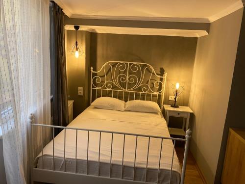 a bedroom with a bed with a wrought iron headboard at Kinzi House in Canakkale