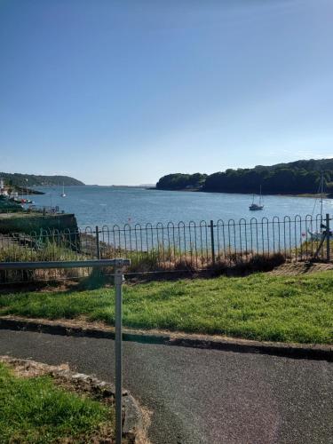 a pole on the side of a road near a body of water at The Old Court House & Jail in Menai Bridge