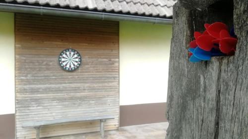 a wooden house with a red and blue decoration on it at Country House Pri Lipet Žiri in Žiri