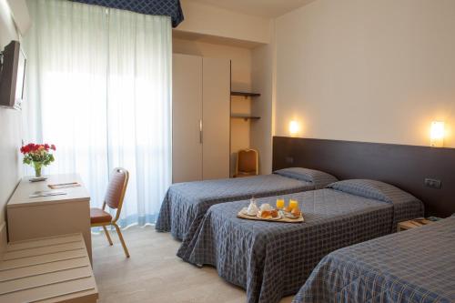 Posteľ alebo postele v izbe v ubytovaní AUTO PARK Hotel
