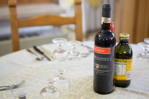 a bottle of wine sitting on a table with glasses at AUTO PARK Hotel in Florence