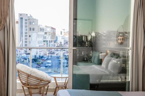 a room with a balcony with a view of a city at Redcon Suites in Hurghada