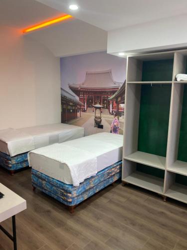 two beds in a room with a building at OFURO WORLD HOTEL SPA in Izmir