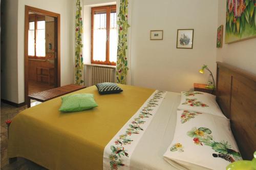 a bedroom with a bed with flowers on it at B&B Casa Certosa in Siena