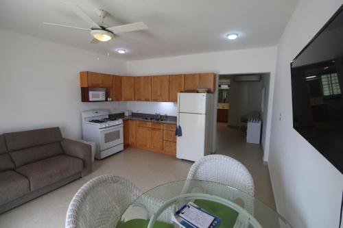 a kitchen and living room with a table and chairs at The Horny Toad Guest House in Simpson Bay