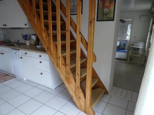 a kitchen with a wooden staircase in a kitchen at Appartement Dorfstrasse in Glücksburg