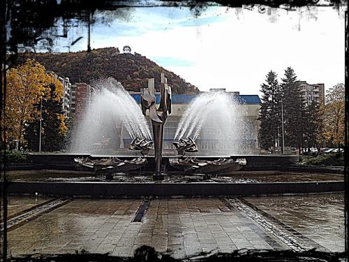a fountain in the middle of a street with at Marcos Apartments - self check-in in Reşiţa