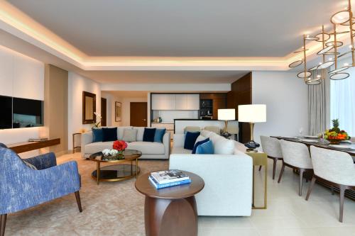 a living room with a couch and a table at Sofitel Dubai The Obelisk in Dubai