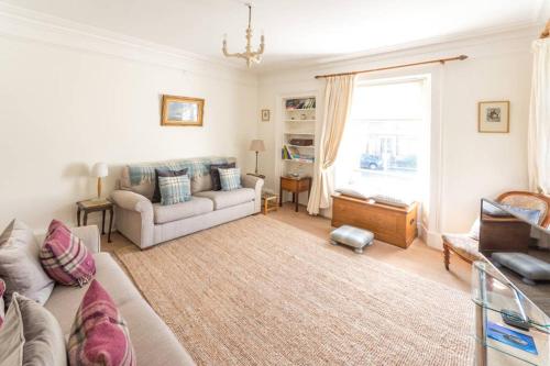 a living room with a couch and a window at Whitehaven in North Berwick