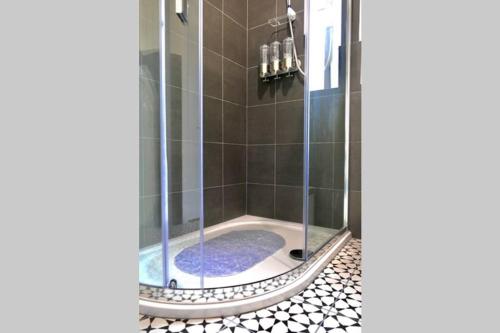 a shower with a glass door in a bathroom at St Brendans Apartment in Elgin