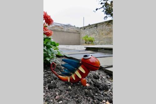 a toy crab is sitting in the dirt at St Brendans Apartment in Elgin