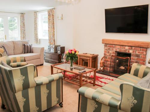 a living room with a couch and a fireplace at Bryn Celyn in Oswestry