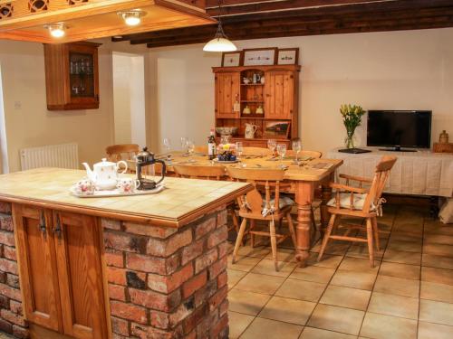 a kitchen with a table and a dining room at Bryn Celyn in Oswestry