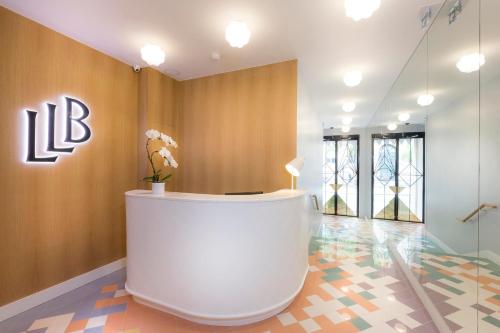 a lobby with a reception desk in a building at Hotel le Lapin Blanc in Paris