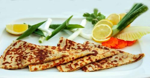 a white plate of food with some food on it at Daraysh Hotel in Sharjah