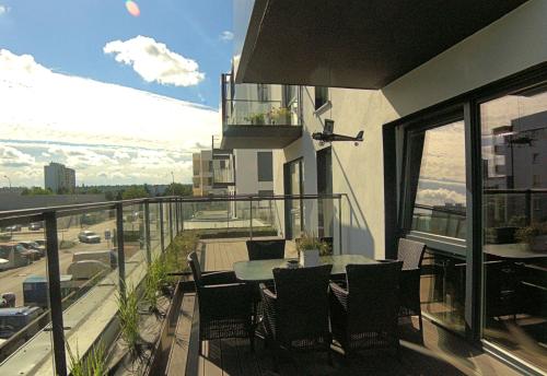 a balcony with a table and chairs on top of a building at Blue Velvet Premium Apartments III in Toruń