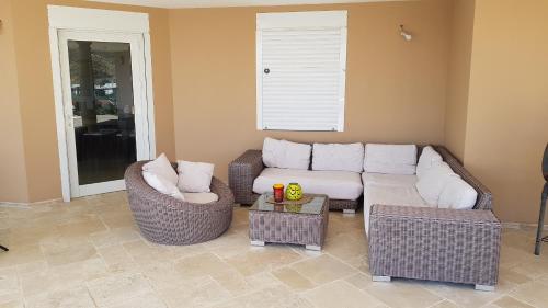 a living room with a couch and chairs and a table at C'RENITY VILLA in Cul de Sac