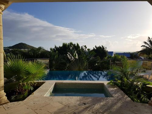 a swimming pool in front of a villa at C'RENITY VILLA in Cul de Sac