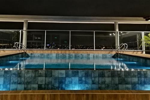 a swimming pool at night with a city view at Dazzler by Wyndham Ciudad del Este in Ciudad del Este