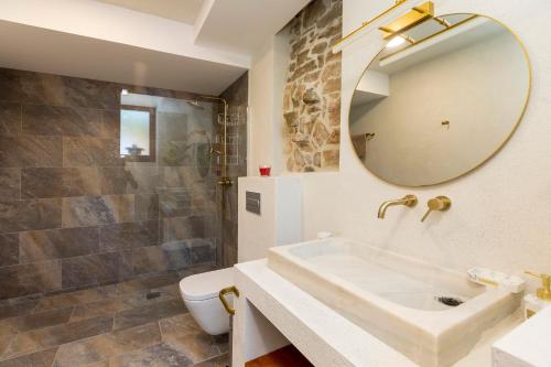 a bathroom with a sink and a mirror at 8 to 10 Sleeps Private Pool Villa & BBQ Near Barcelona in Rocafort