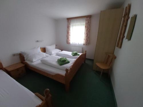 a small bedroom with a bed and a window at Ferienhaus Fallenegger in Flachau