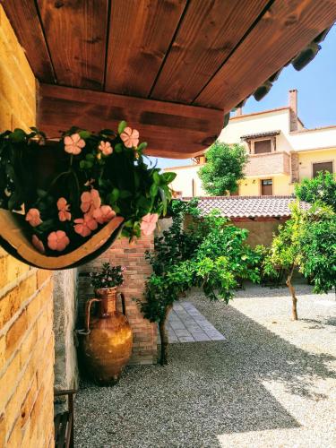 a bunch of flowers in a pot hanging from a wall at BORGO LUNA b&b in Manduria