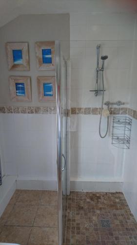 a bathroom with a shower with a glass door at The Old Post Office B&B in Lymm