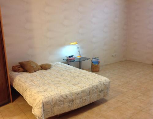 a bedroom with a bed and a table with a lamp at Квартира-студия in Kharkiv