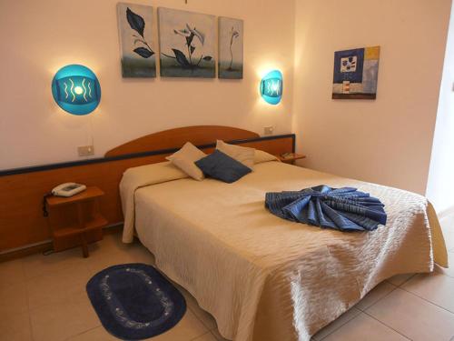 a bedroom with a large bed in a room at Hotel Toscana in Marotta