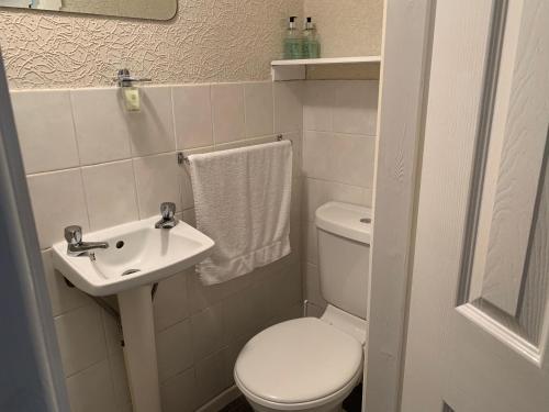 a small bathroom with a toilet and a sink at Sharn Bek Hotel in Blackpool