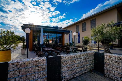 a restaurant with tables and benches in front of a building at Hotel Viktorosa in Hofgeismar