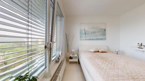 Ένα ή περισσότερα κρεβάτια σε δωμάτιο στο BIBI Centroom Apartment