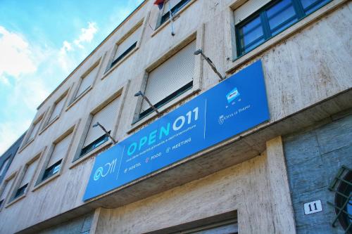 a blue sign on the side of a building at Open011 in Turin