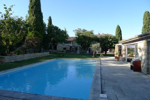 a swimming pool in front of a house at Terralha in Meynes